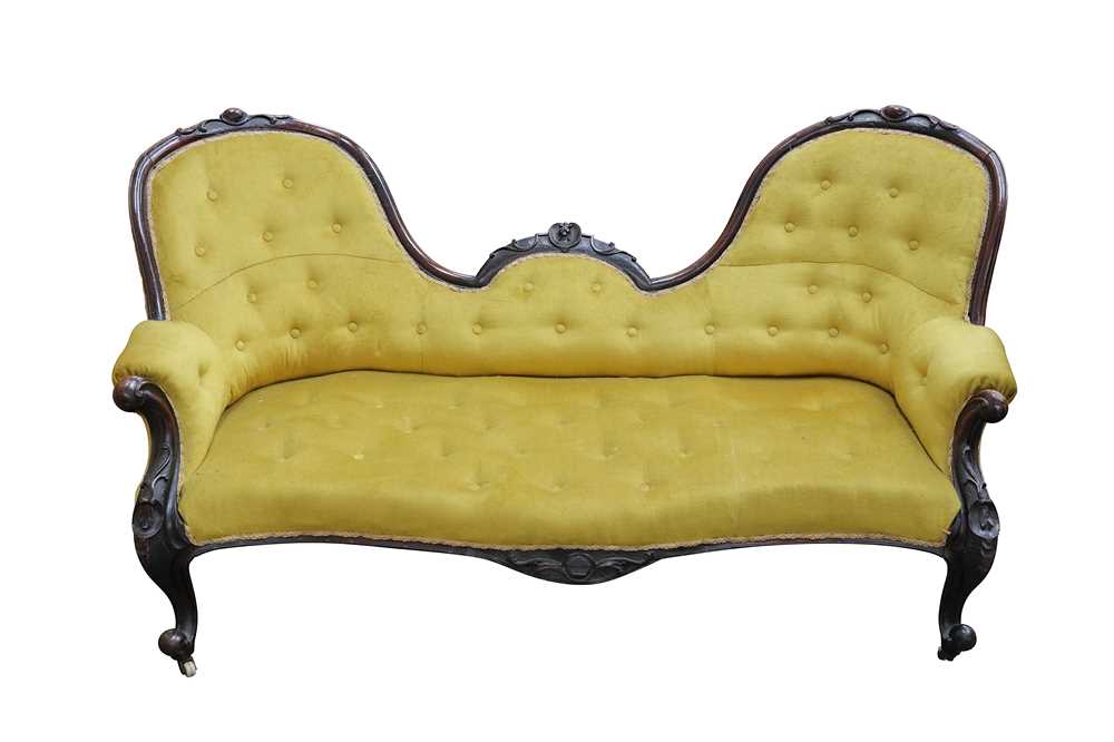 Lot 611 - A Victorian carved rosewood double spoon back sofa
