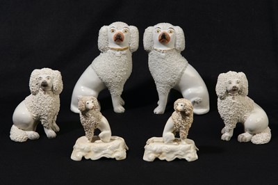 Lot 205 - Three pairs of Staffordshire porcelain seated poodles