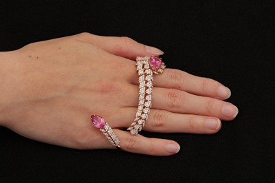 Lot 77 - A pink tourmaline and diamond two-finger dress ring