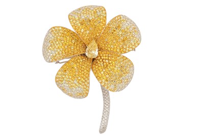 Lot 131 - A yellow sapphire and diamond floral brooch