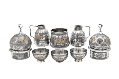 Lot 278 - An early 20th century Syrian gold inlaid unmarked silver six-piece Turkish coffee set, Damascus circa 1920