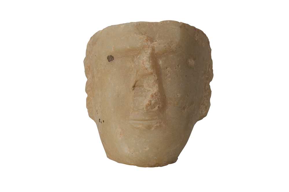 Lot 7 - A SOUTH ARABIAN ALABASTER HEAD OF A MAN, CIRCA 1ST CENTURY B.C.- 1ST CENTURY A.D.