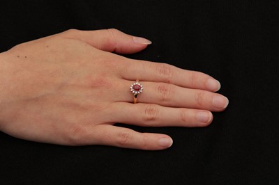 Lot 138 - A ruby and diamond gold cluster ring