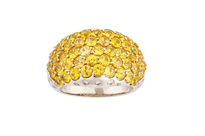 Lot 111 - A yellow sapphire and diamond dress ring