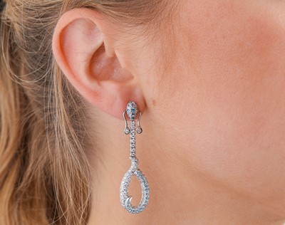 Lot 91 - A pair of blue topaz and diamond pendent earrings