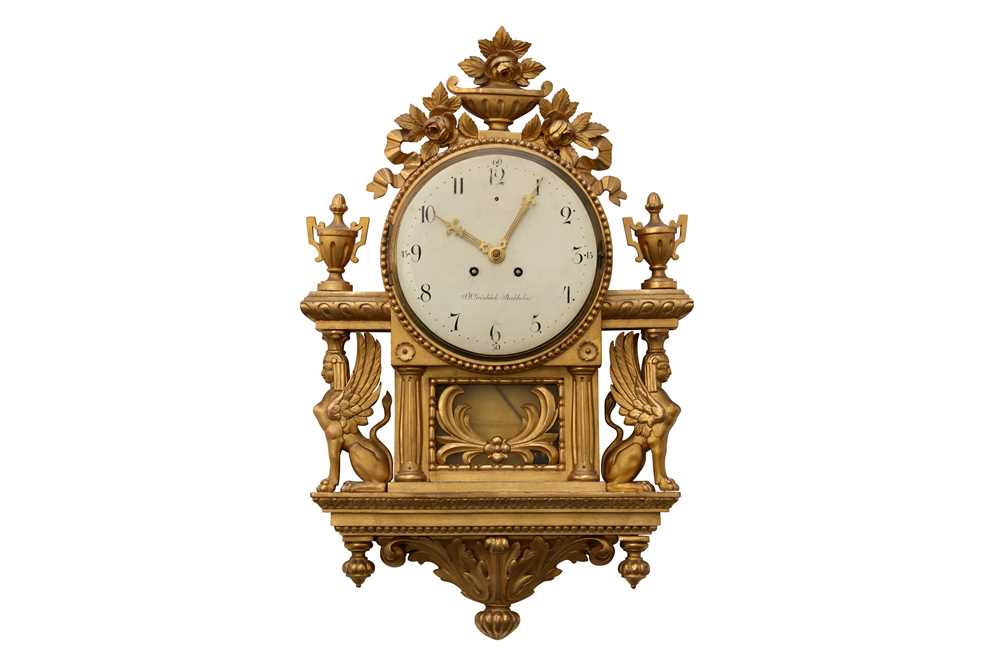 Lot 36 - A 19TH CENTURY AND LATER SWEDISH GILTWOOD WALL CLOCK IN THE EMPIRE STYLE