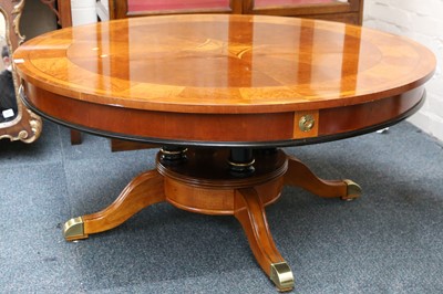 Lot 74 - A circular top low table raised on a turned...