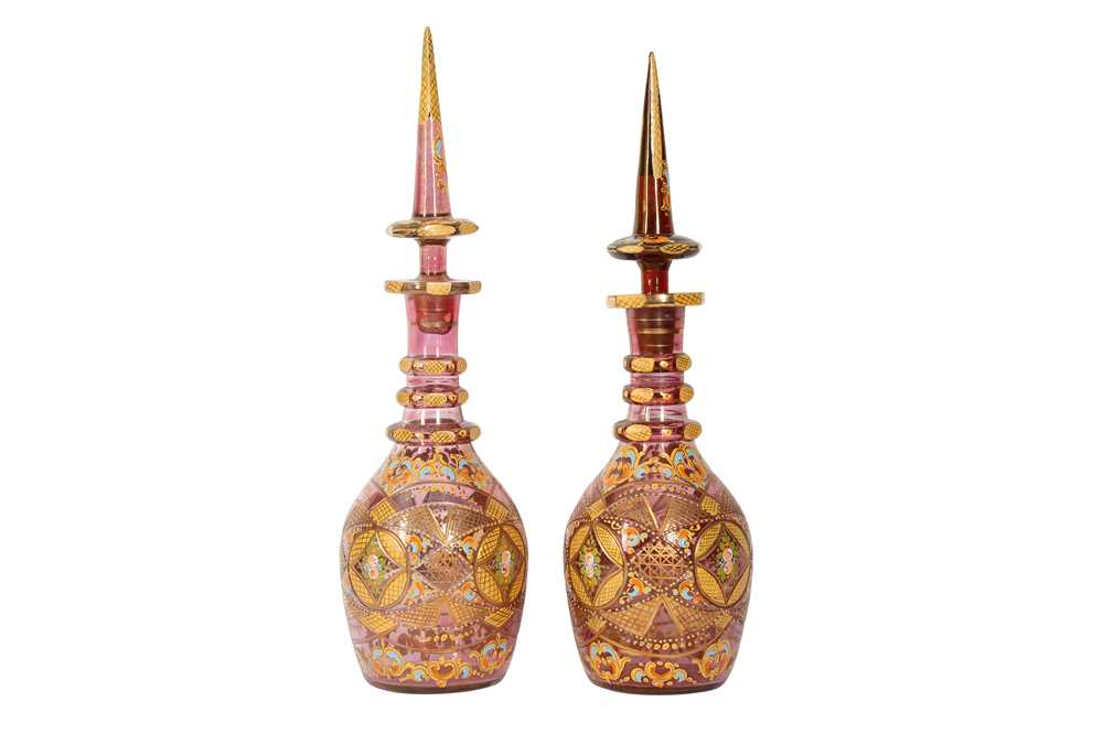 Lot 912 - A PAIR OF GILT AND POLYCHROME-PAINTED BOHEMIA PINK CUT-GLASS SPIRIT DECANTERS FOR THE IRANIAN MARKET