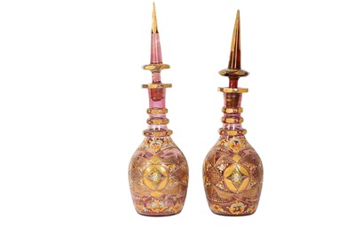 Lot 912 - A PAIR OF GILT AND POLYCHROME-PAINTED BOHEMIA PINK CUT-GLASS SPIRIT DECANTERS FOR THE IRANIAN MARKET