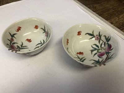 Lot 570 - A PAIR OF CHINESE FAMILLE ROSE 'BATS AND PEACHES' BOWLS.