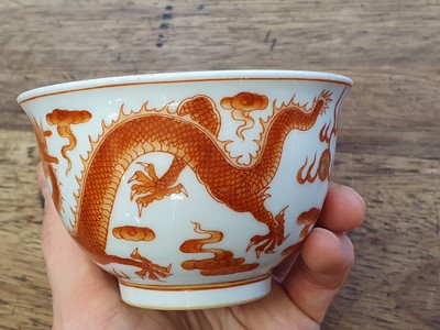 Lot 623 - A CHINESE IRON RED 'DRAGON' CUP.