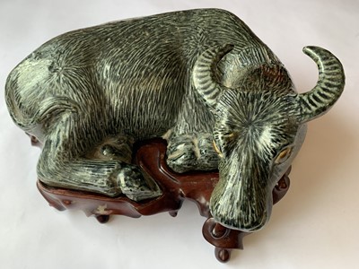 Lot 592 - A CHINESE BISCUIT GREEN-GLAZED MODEL OF A BUFFALO.