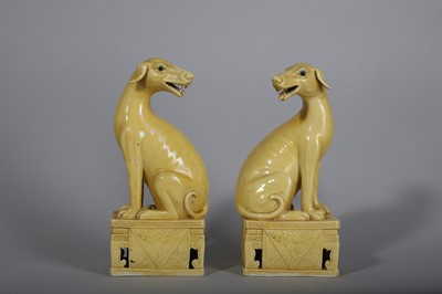 Lot 166 - A PAIR OF CHINESE YELLOW GLAZED HOUNDS.