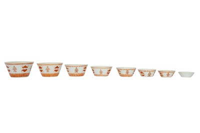 Lot 722 - A SET OF EIGHT CHINESE IRON-RED AND GILT 'WELLWISHING' CUPS.