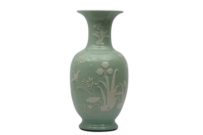 Lot 773 - A CHINESE SLIP-DECORATED CELADON VASE.