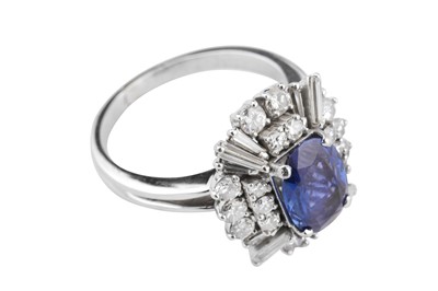 Lot 1294 - A sapphire and diamond dress ring, circa 1965