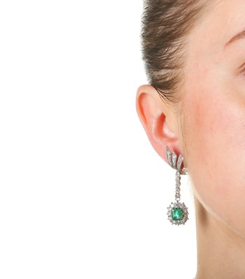 Lot 1225 - A pair of emerald and diamond earrings