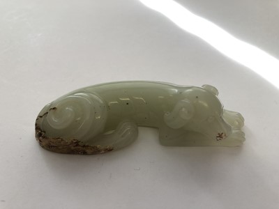 Lot 478 - A CHINESE PALE CELADON JADE CARVING OF A DOG.