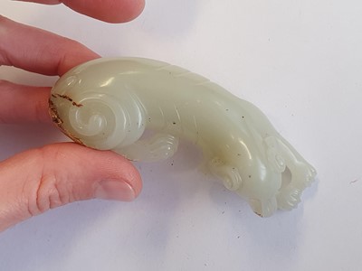 Lot 478 - A CHINESE PALE CELADON JADE CARVING OF A DOG.