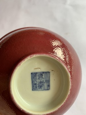 Lot 126 - A SET OF NINE SMALL CHINESE COPPER RED-GLAZED BOWLS.