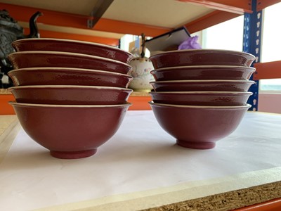 Lot 74 - A SET OF TEN CHINESE COPPER RED-GLAZED BOWLS.
