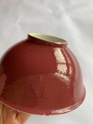 Lot 74 - A SET OF TEN CHINESE COPPER RED-GLAZED BOWLS.