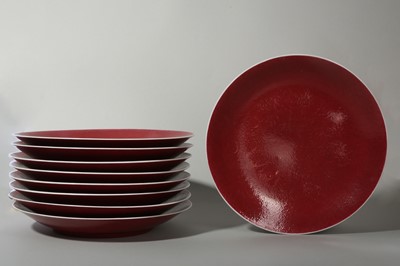 Lot 79 - A SET OF NINE LARGE CHINESE COPPER RED GLAZED DISHES.