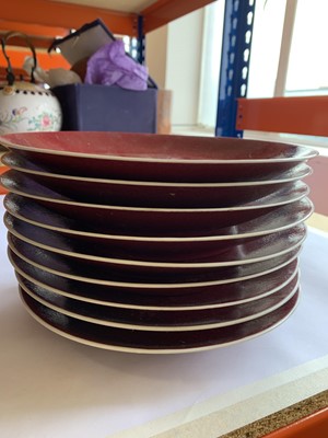 Lot 79 - A SET OF NINE LARGE CHINESE COPPER RED GLAZED DISHES.