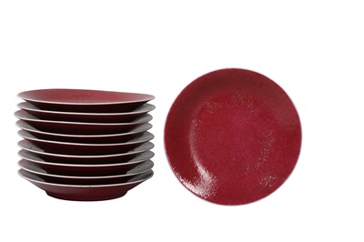 Lot 127 - A SET OF TEN CHINESE COPPER RED-GLAZED DISHES.
