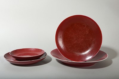 Lot 76 - A SET OF FOUR COPPER RED-GLAZED DISHES.