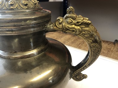 Lot 30 - A TIBETAN PEWTER AND COPPER MILK TEAPOT AND COVER.