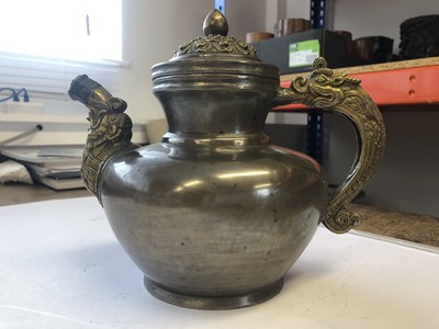 Lot 761 - A TIBETAN PEWTER AND COPPER MILK TEAPOT AND COVER.