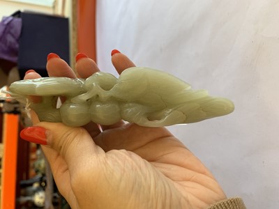 Lot 703 - A CHINESE PALE CELADON JADE 'BIRD AND LINGZHI' CARVING.