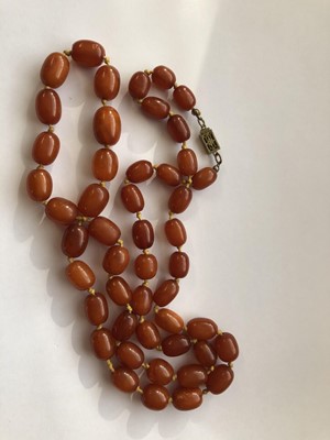 Lot 104 - TWO AMBER BEAD NECKLACES.