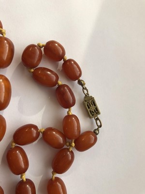 Lot 104 - TWO AMBER BEAD NECKLACES.