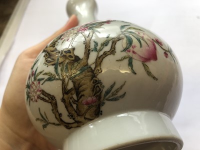 Lot 569 - A PAIR OF CHINESE FAMILLE ROSE GARLIC MOUTH 'PEACHES' VASES.