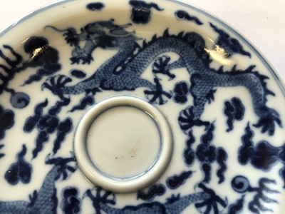 Lot 629 - A CHINESE BLUE AND WHITE 'DRAGON' CUP AND SAUCER.