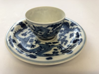 Lot 629 - A CHINESE BLUE AND WHITE 'DRAGON' CUP AND SAUCER.