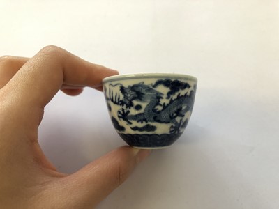 Lot 629 - A CHINESE BLUE AND WHITE 'DRAGON' CUP AND SAUCER.