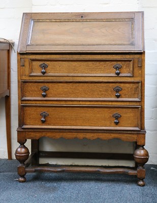 Lot 467 - A 1930s oak bureau, the fall front enclosing...