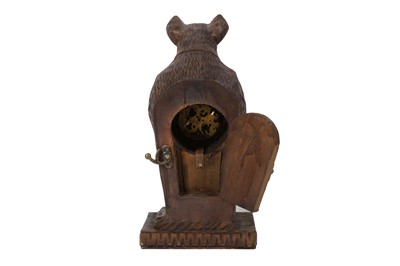 Lot 124 - A BLACK FOREST STYLE CARVED WOODEN MANTLE CLOCK
