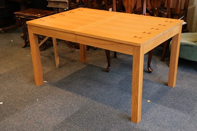 Lot 469 - A modern blond oak and inlaid extending dining...