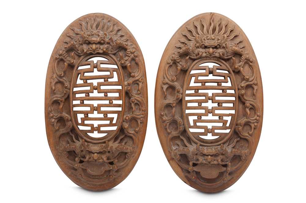 Lot 385 - A PAIR OF WOOD CARVED OVAL PANELS.