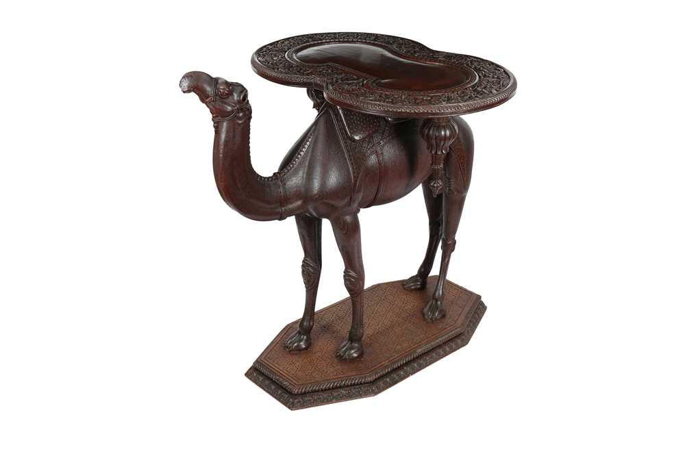 Lot 871 - AN ANGLO-INDIAN CARVED HARDWOOD OCCASIONAL CAMEL TABLE