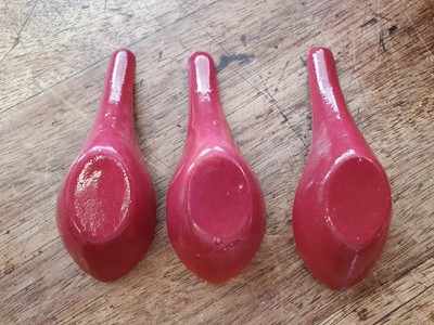 Lot 128 - A SET OF FIVE CHINESE COPPER RED GLAZED SPOONS.