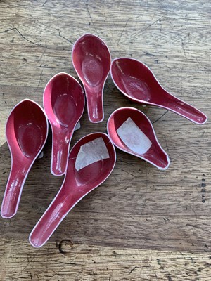 Lot 75 - A SET OF FIVE CHINESE COPPER RED GLAZED SPOONS.