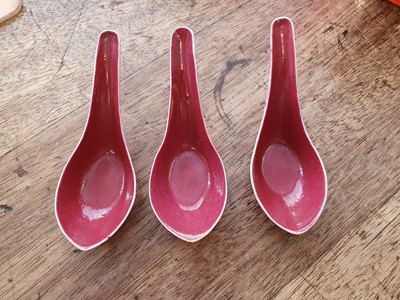 Lot 75 - A SET OF FIVE CHINESE COPPER RED GLAZED SPOONS.