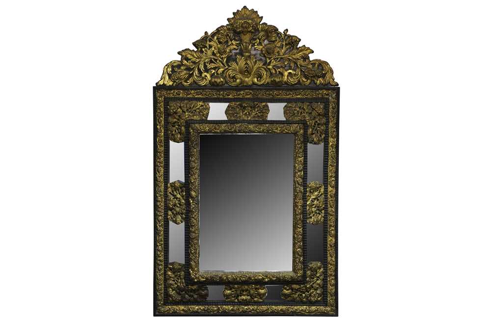 Lot 617 - A late 19th century Flemish gilt and ebonised cushion framed mirror