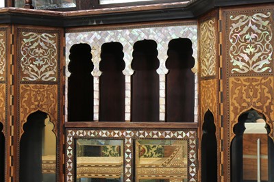 Lot 843 - λ A HARDWOOD MOTHER-OF-PEARL-INLAID LIBERTY & CO. OTTOMAN-REVIVAL ORIENTALIST CUPBOARD