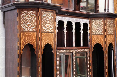 Lot 843 - λ A HARDWOOD MOTHER-OF-PEARL-INLAID LIBERTY & CO. OTTOMAN-REVIVAL ORIENTALIST CUPBOARD
